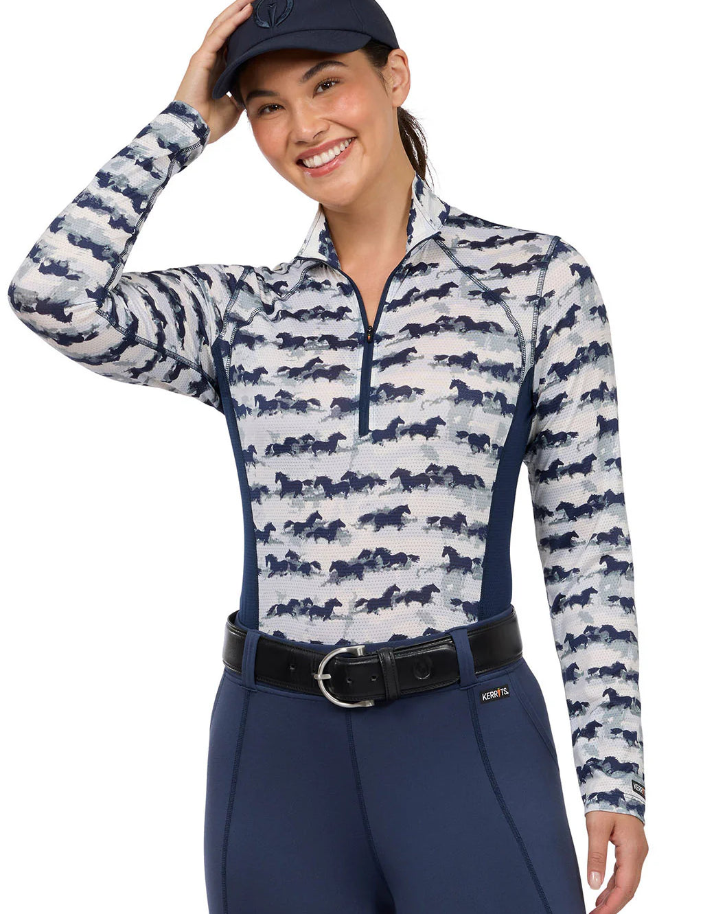 Woman wearing a horse print long sleeve riding shirt, front view
