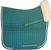 Green quilted dressage pad with cream piping with natural  sheepskin lining