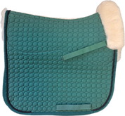 Green quilted dressage pad with black piping with natural  sheepskin lining