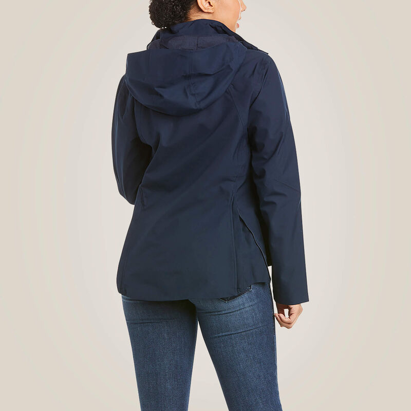 Back view of a female model wearing the Navy Ariat Coastal Waterproof Jacket on a plain background
