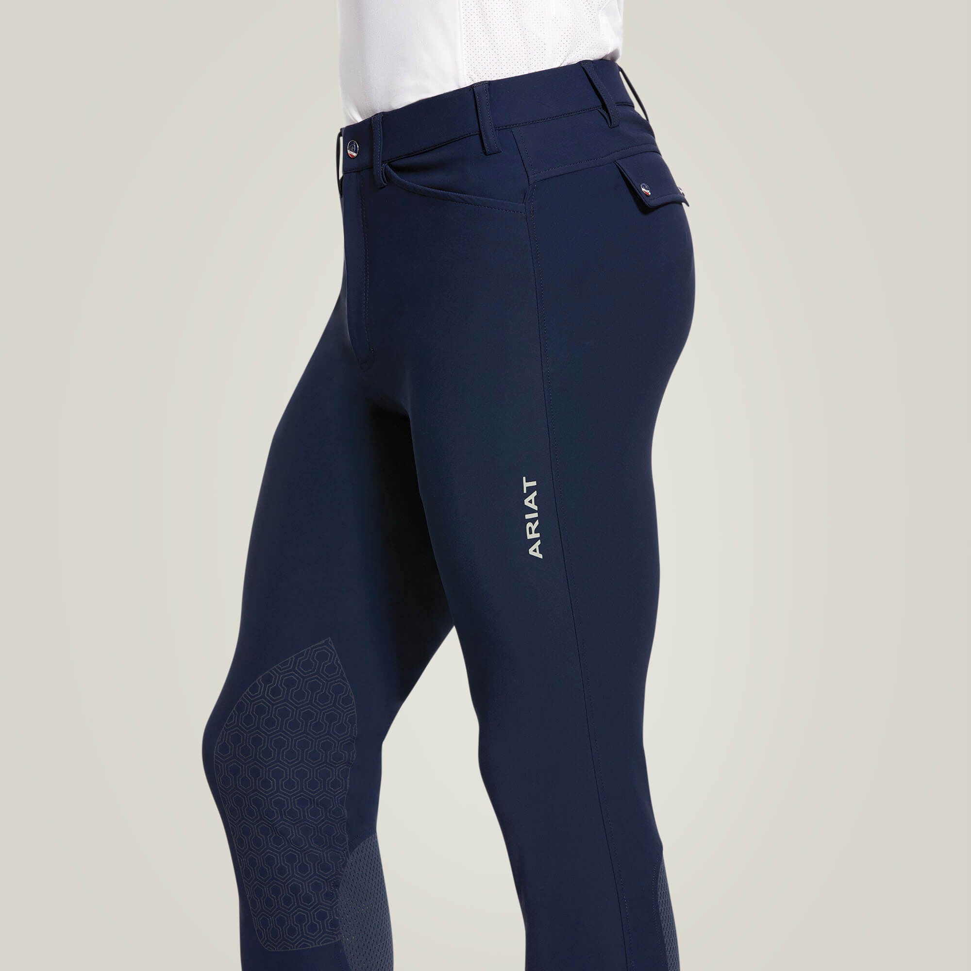 Side view of a male model wearing the Black Ariat Men's Tri Factor Knee Patch Breeches on a plain background