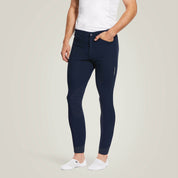 Front view of a male model wearing the Navy Ariat Men's Tri Factor Knee Patch Breeches on a plain background