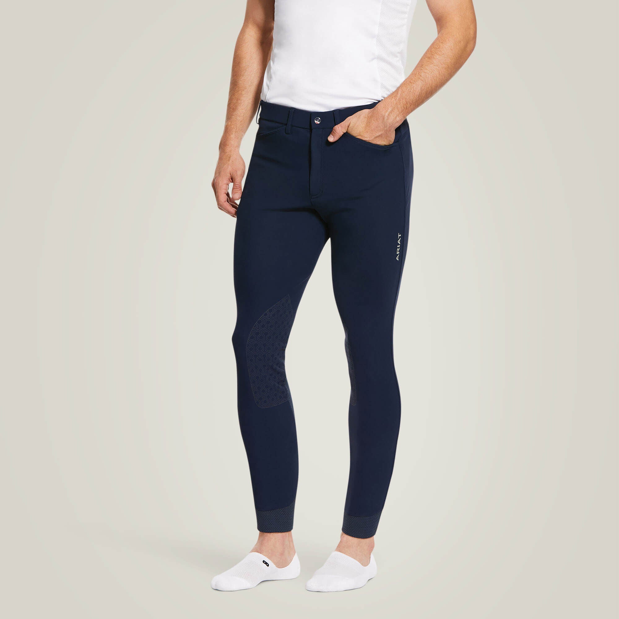 Front view of a male model wearing the Navy Ariat Men's Tri Factor Knee Patch Breeches on a plain background
