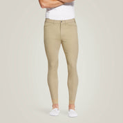 Front view of a male model wearing the Tan Ariat Men's Tri Factor Knee Patch Breeches on a plain background