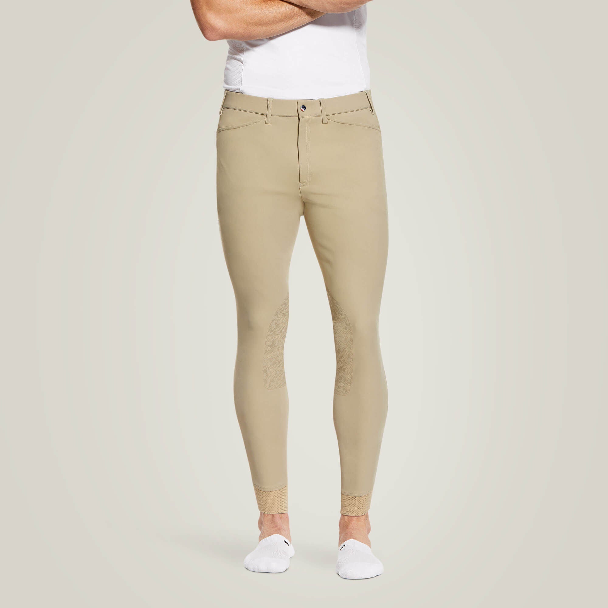 Front view of a male model wearing the Tan Ariat Men's Tri Factor Knee Patch Breeches on a plain background