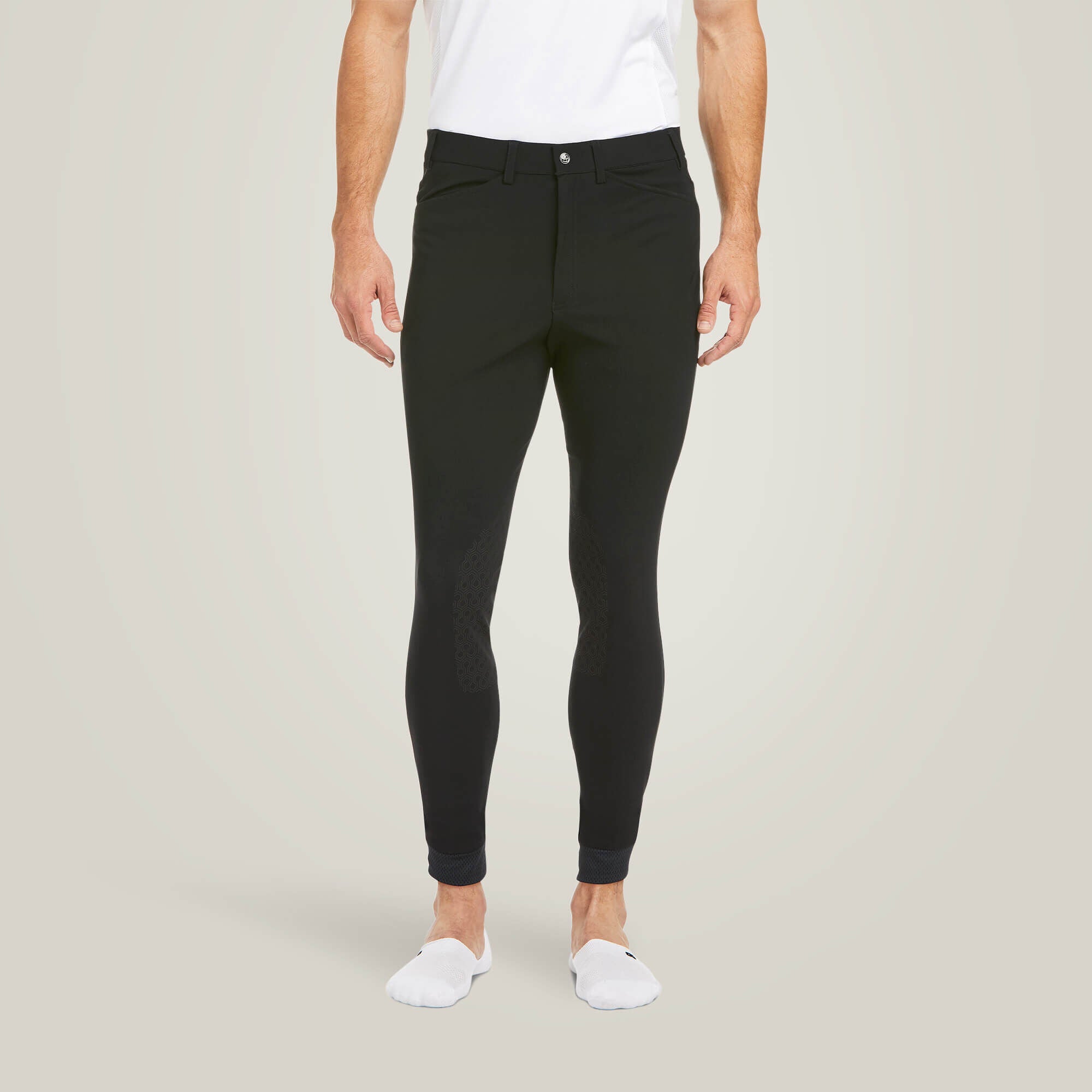 Front view of a male model wearing the Black Ariat Men's Tri Factor Knee Patch Breeches on a plain background