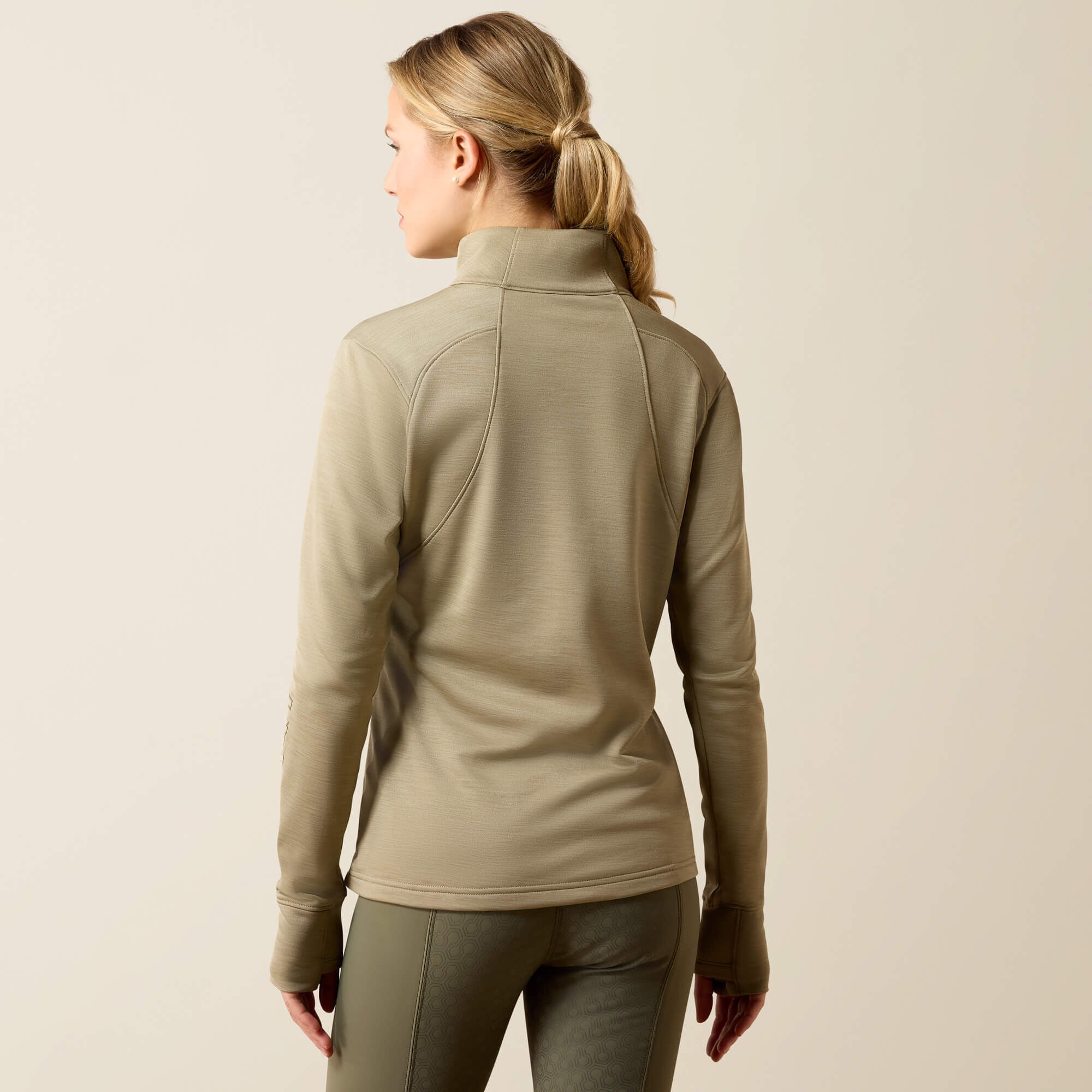 Back view of a model wearing the Winter Twig Ariat Team EQ 1/2 Zip Pullover on a plain background