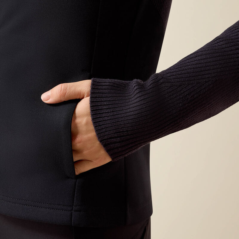 Side closeup view of a model wearing the Ariat Skadi Full Zip with her hand in a pocket