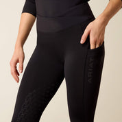 Front closeup view of a model wearing the Black Ariat Avail 2.0 HG Tight on a plain background showing the Trizar grip and pocket area