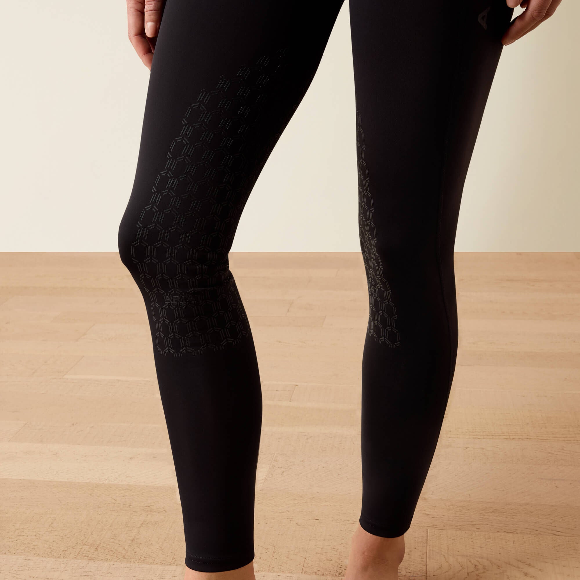 Front closeup view of a model wearing the Black Ariat Avail 2.0 HG Tight on a plain background showing the Trizar grip