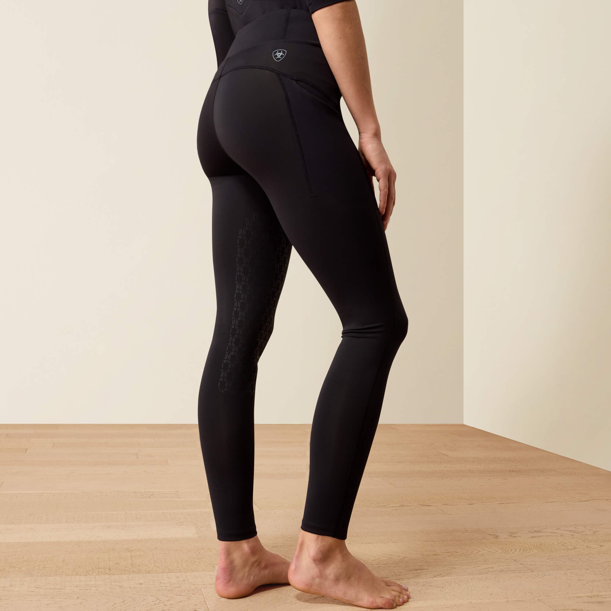 Back view of a model wearing the Black Ariat Avail 2.0 HG Tight on a plain background