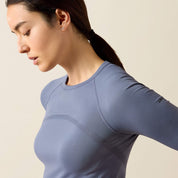 Angled side view of a model wearing the Grisaille Ariat Sustain Long Sleeve Baselayer
