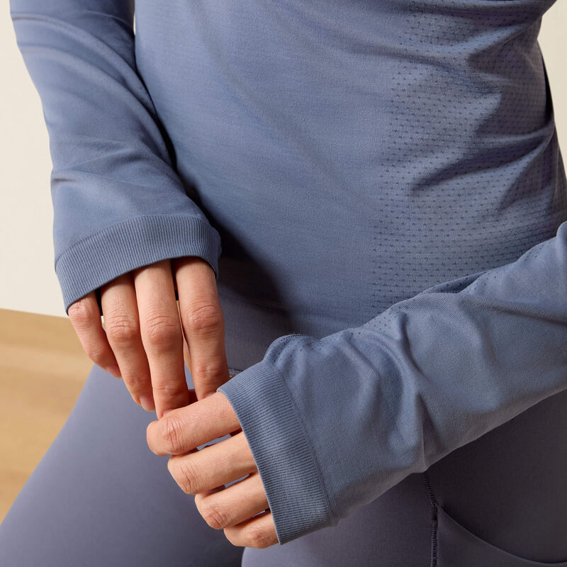 Front closeup view a model wearing the Grisaille Ariat Sustain Long Sleeve Baselayer showing the ends of the sleeves