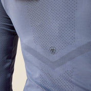 Back closeup view of a model wearing the Grisaille Ariat Sustain Long Sleeve Baselayer showing the Ariat logo