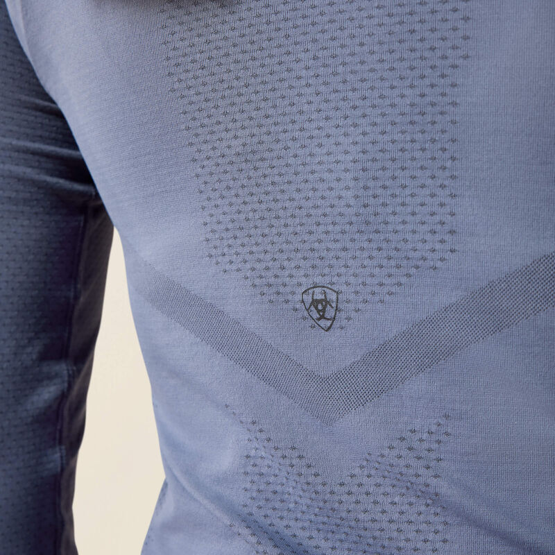Back closeup view of a model wearing the Grisaille Ariat Sustain Long Sleeve Baselayer showing the Ariat logo