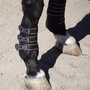 Close-up of a horse’s lower leg wearing a Majyk Equipe Boyd Martin leather tendon boot