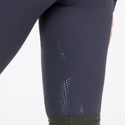 Close-up view of the silicone grip on the Aubrion React Winter Knee Patch Riding Tights on a plain background