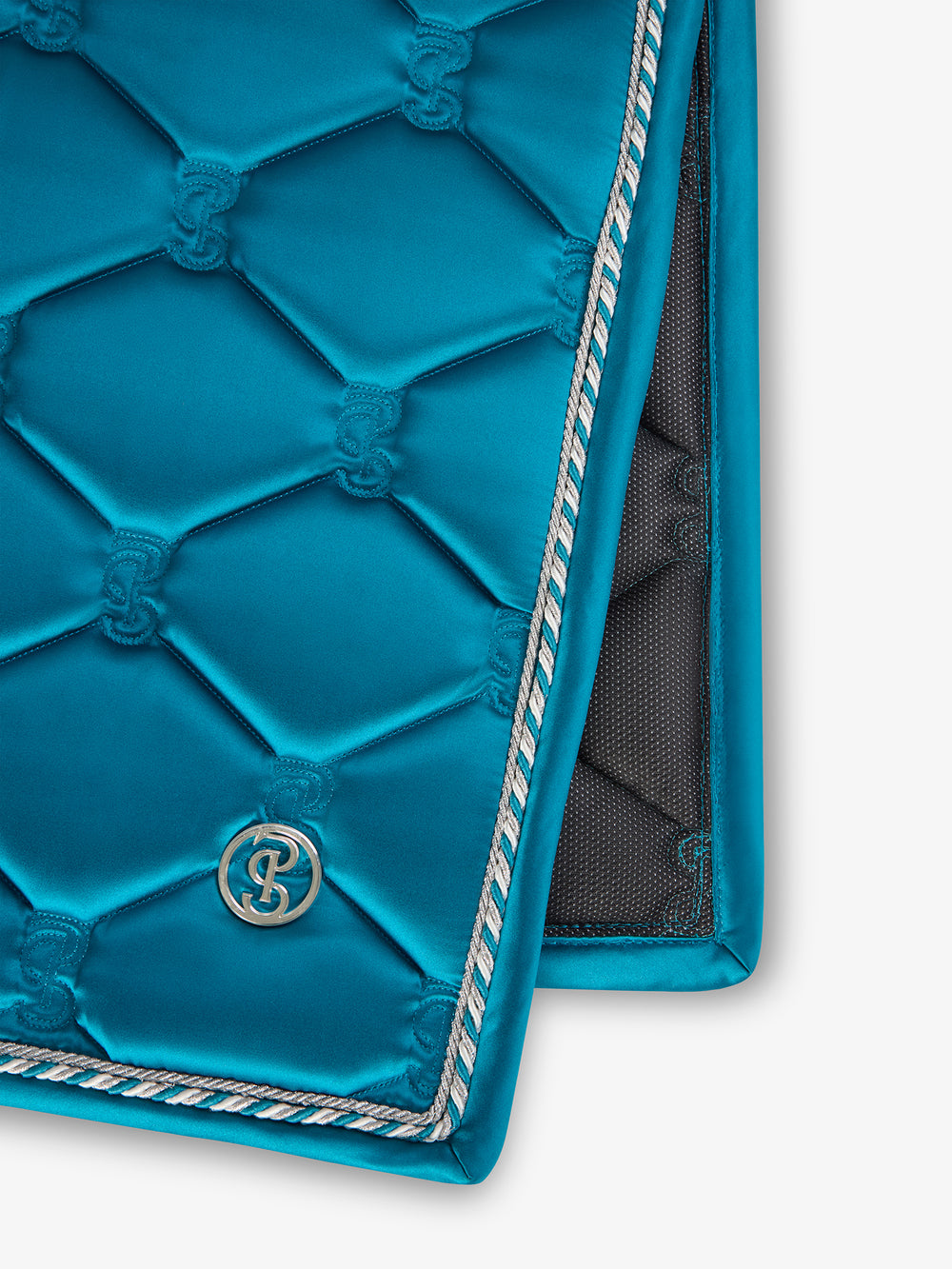 Close-up view of the logo and trim on the Evening Teal PS of Sweden Signature Dressage Pad on a white background