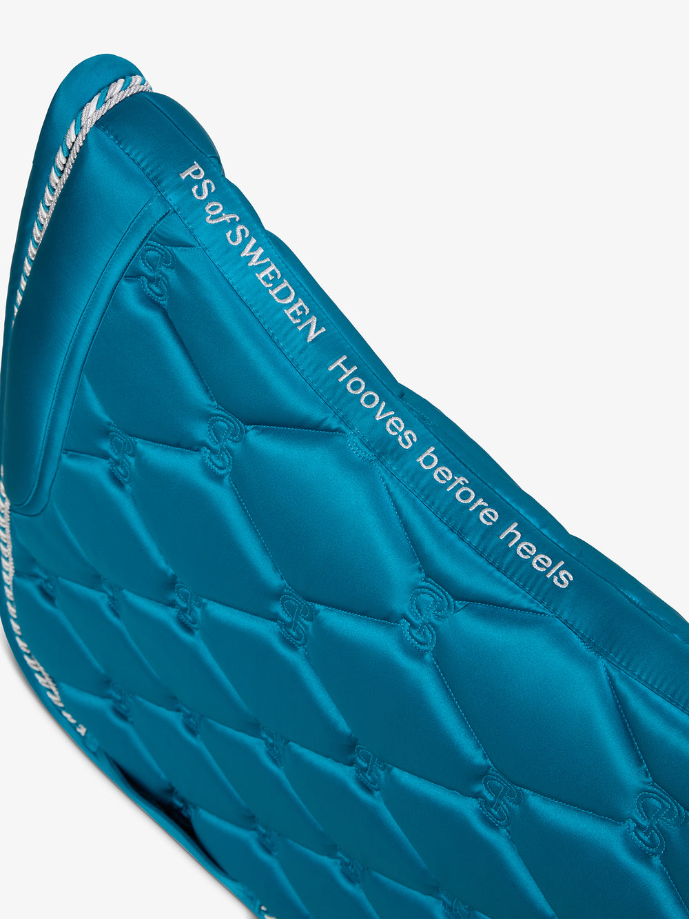 Close-up view of the spine on the Evening Teal PS of Sweden Signature Dressage Pad on a white background