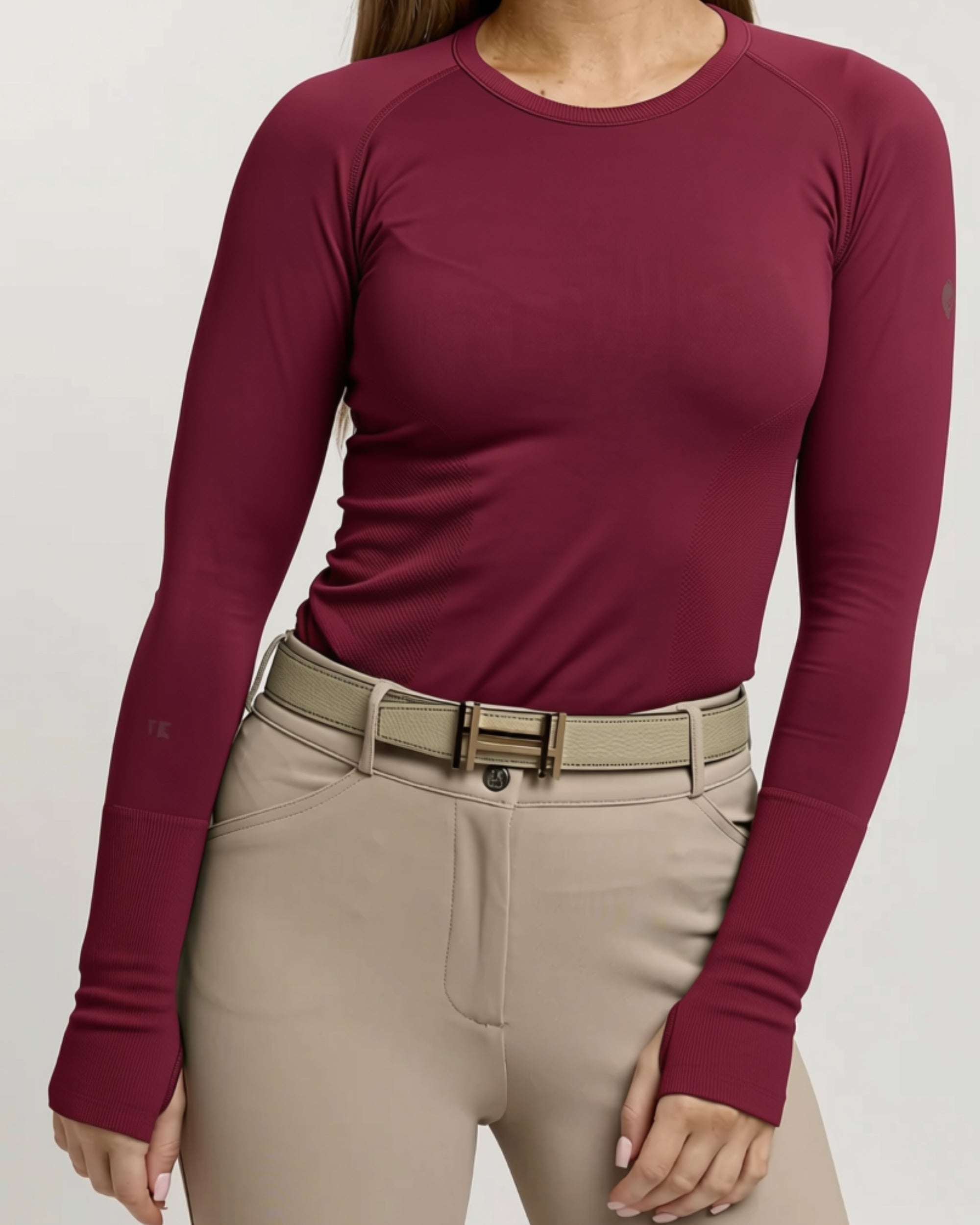 Front view of a female model wearing the Fizz TKEQ Kennedy Seamless Long Sleeve Shirt 2.0 on a plain background