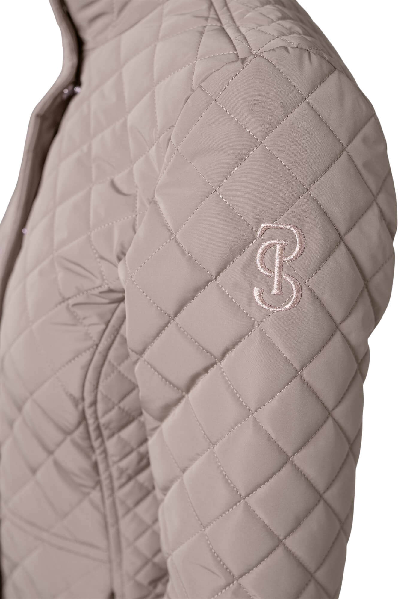 Tan quilted jacket with zipper cover and short collar shown, with embroidered logo on shoulder on model on plain white background