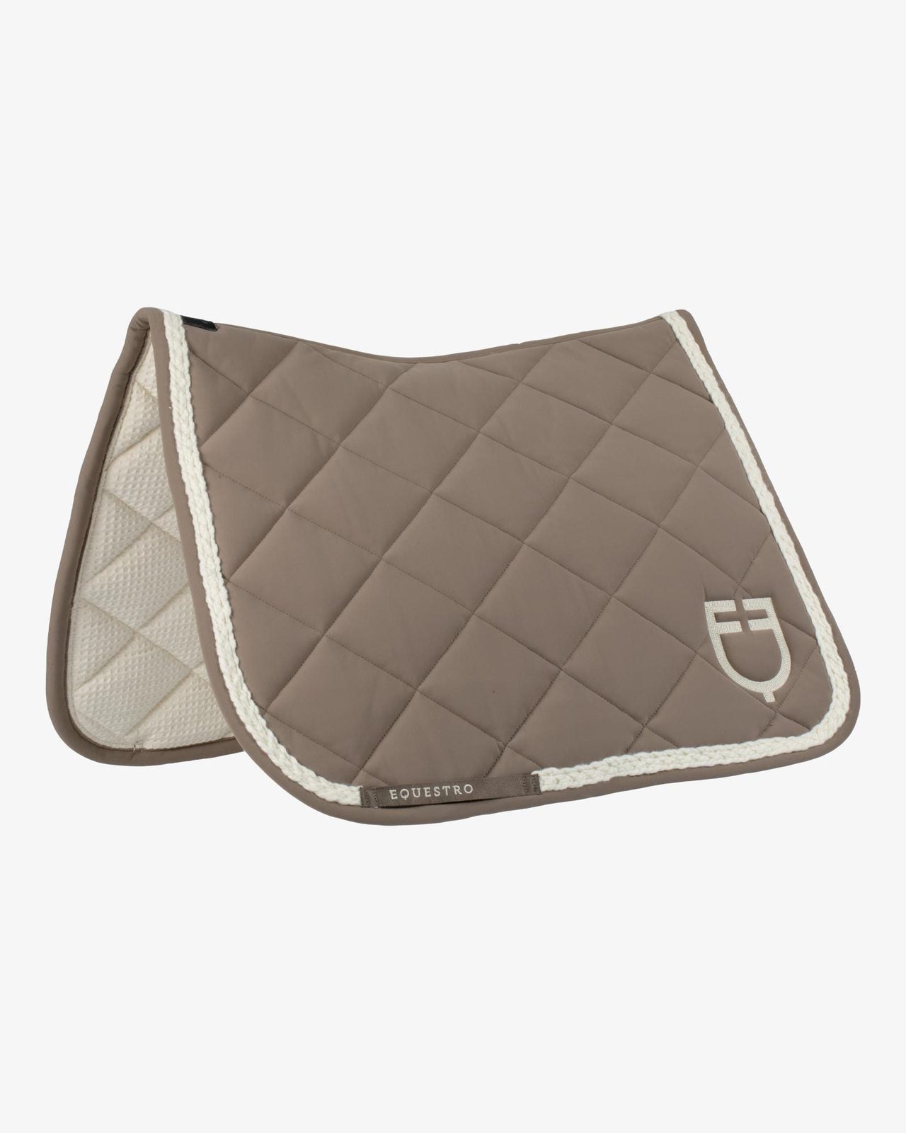 Tan quilted saddle pad with ivory braided trim and logo shown on a plain white background