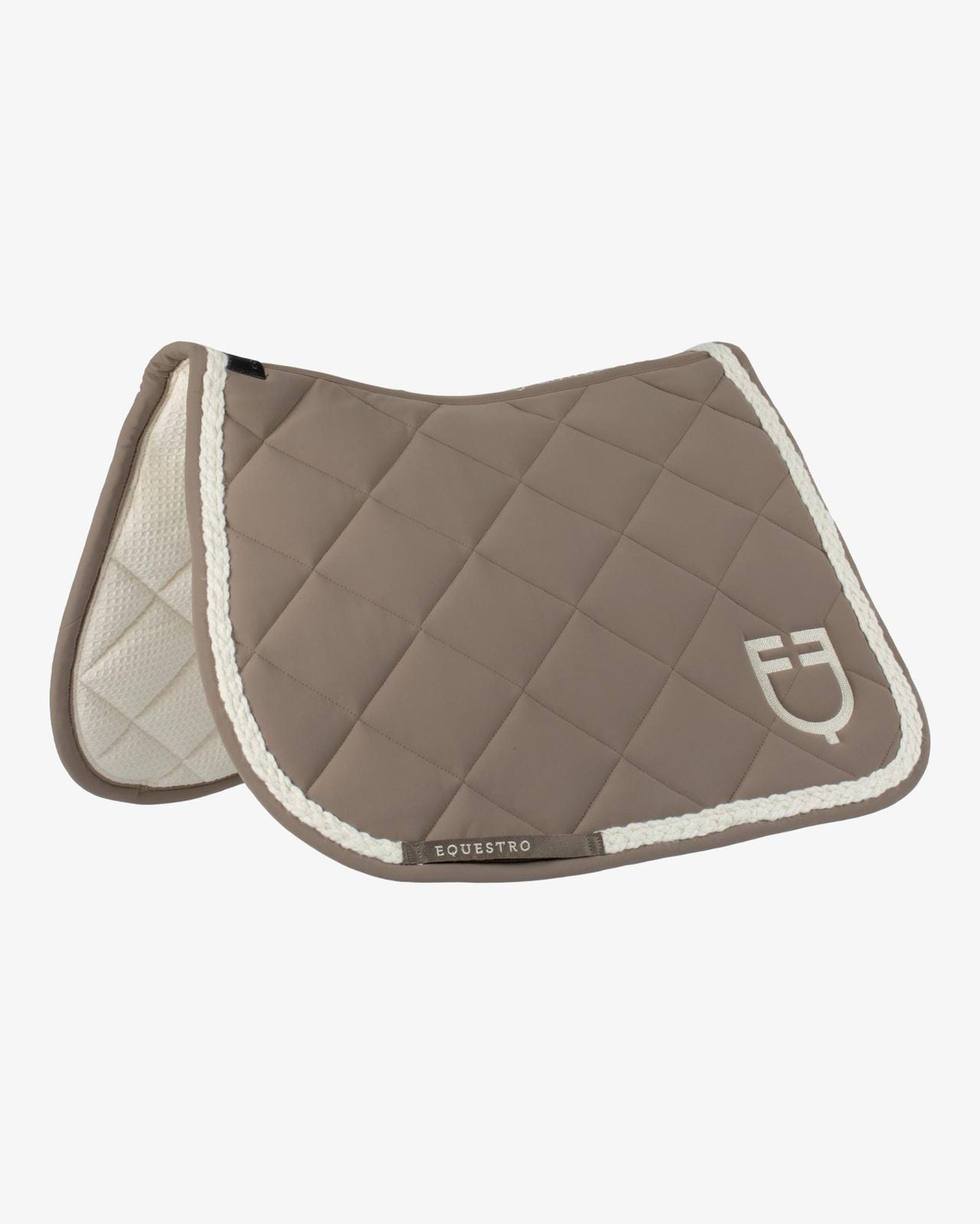 Tan quilted saddle pad with braided ivory trim and logo shown on plain white background