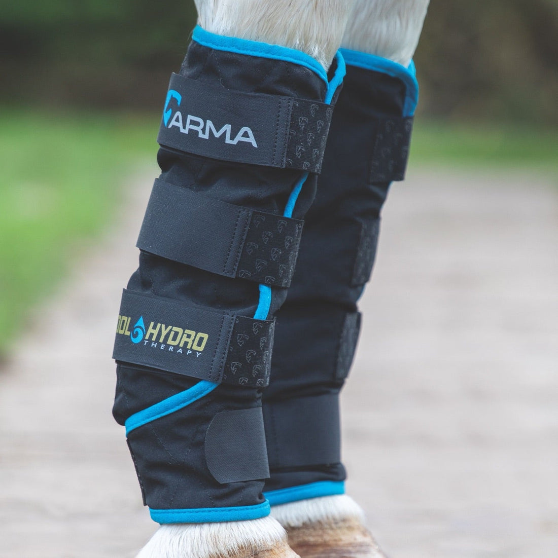 Side view of a horse wearing a pair of ARMA Cool Hydro Therapy Boots while standing on a path outside