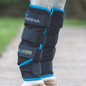 Side view of a horse wearing a pair of ARMA Cool Hydro Therapy Boots while standing on a path outside
