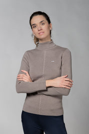 Front view of a female model wearing the Hazel Schockemohle Josie Turtleneck Sweater on a plain background