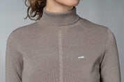 Close-up front view of a female model wearing the Hazel Schockemohle Josie Turtleneck Sweater on a plain background