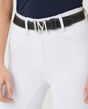 Front view of a female model wearing the Black LeMieux Monogram Belt over white breeches