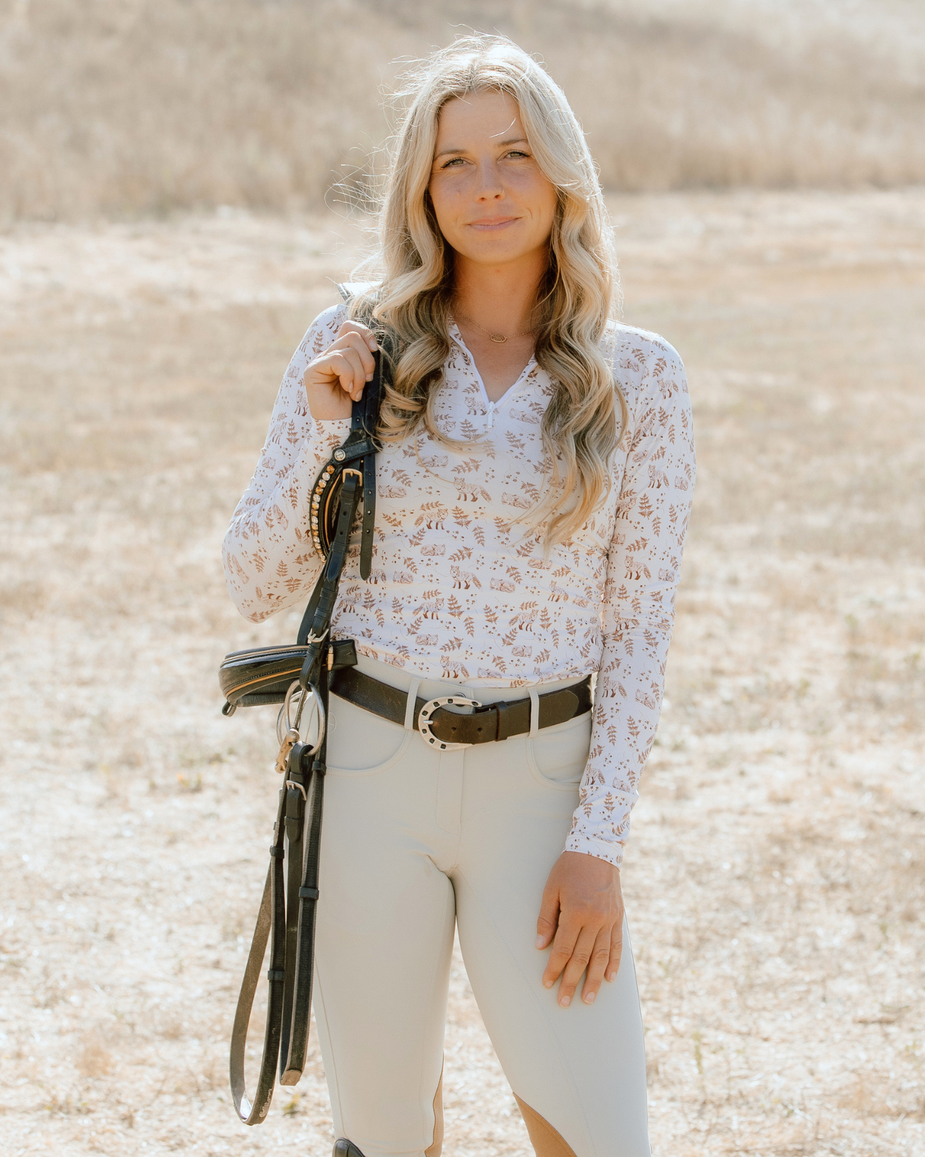 Front view of a female model wearing the Deinhardt Designs Impulsion & Straightness Lori Long Sleeve Signature Sunshirt while standing outside