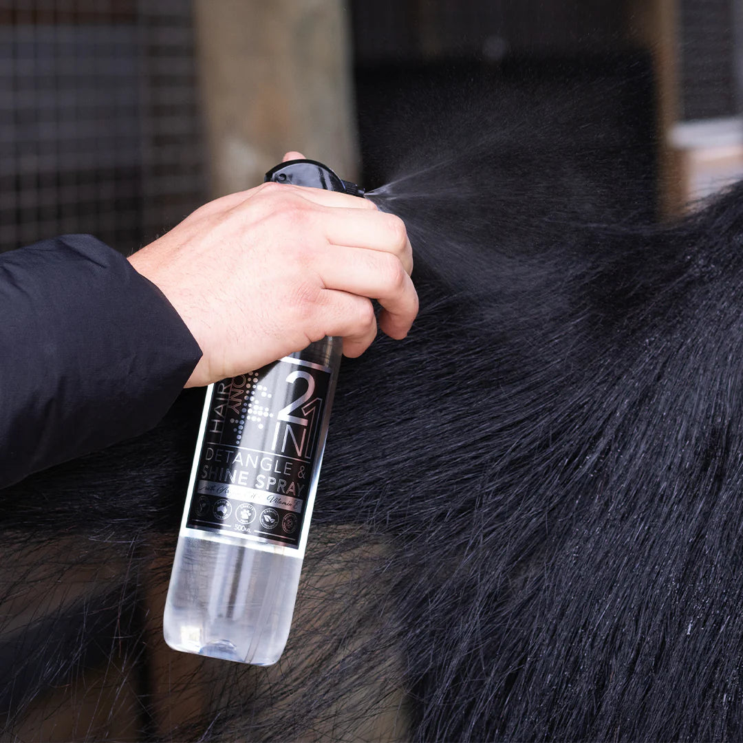 Hand spraying Hairy Pony Detangle & Shine Spray on a horse's tail