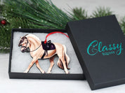 Angled front view of the Dun Fjord Classy Equine Under Saddle Horse Ornament in its gift packaging