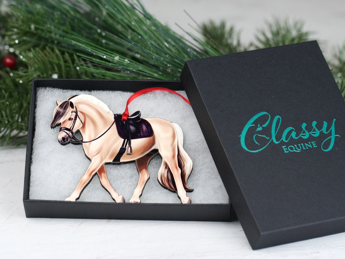 Angled front view of the Dun Fjord Classy Equine Under Saddle Horse Ornament in its gift packaging