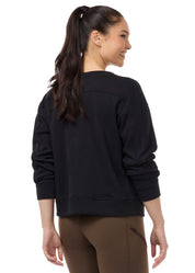 Back view of a female model wearing the Black Kerrits Cozy Crest Plush Fleece Sweatshirt on a plain background
