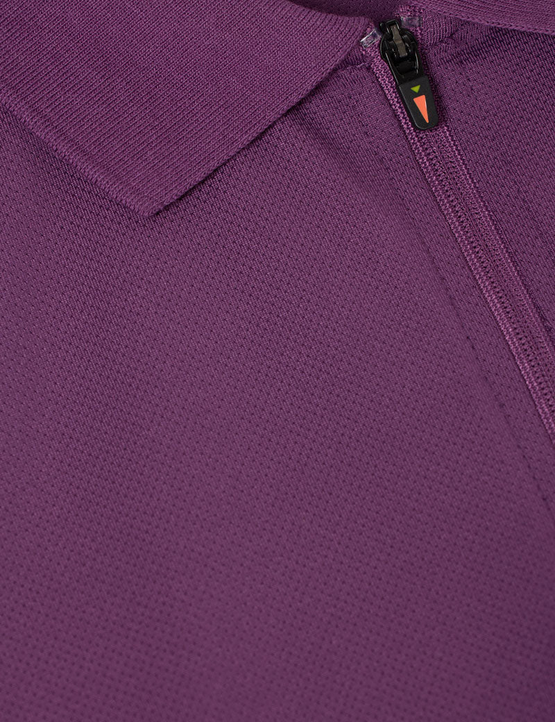 Close-up view of the zipper on the purple Kerrits Serenity Coolcore Short Sleeve Polo