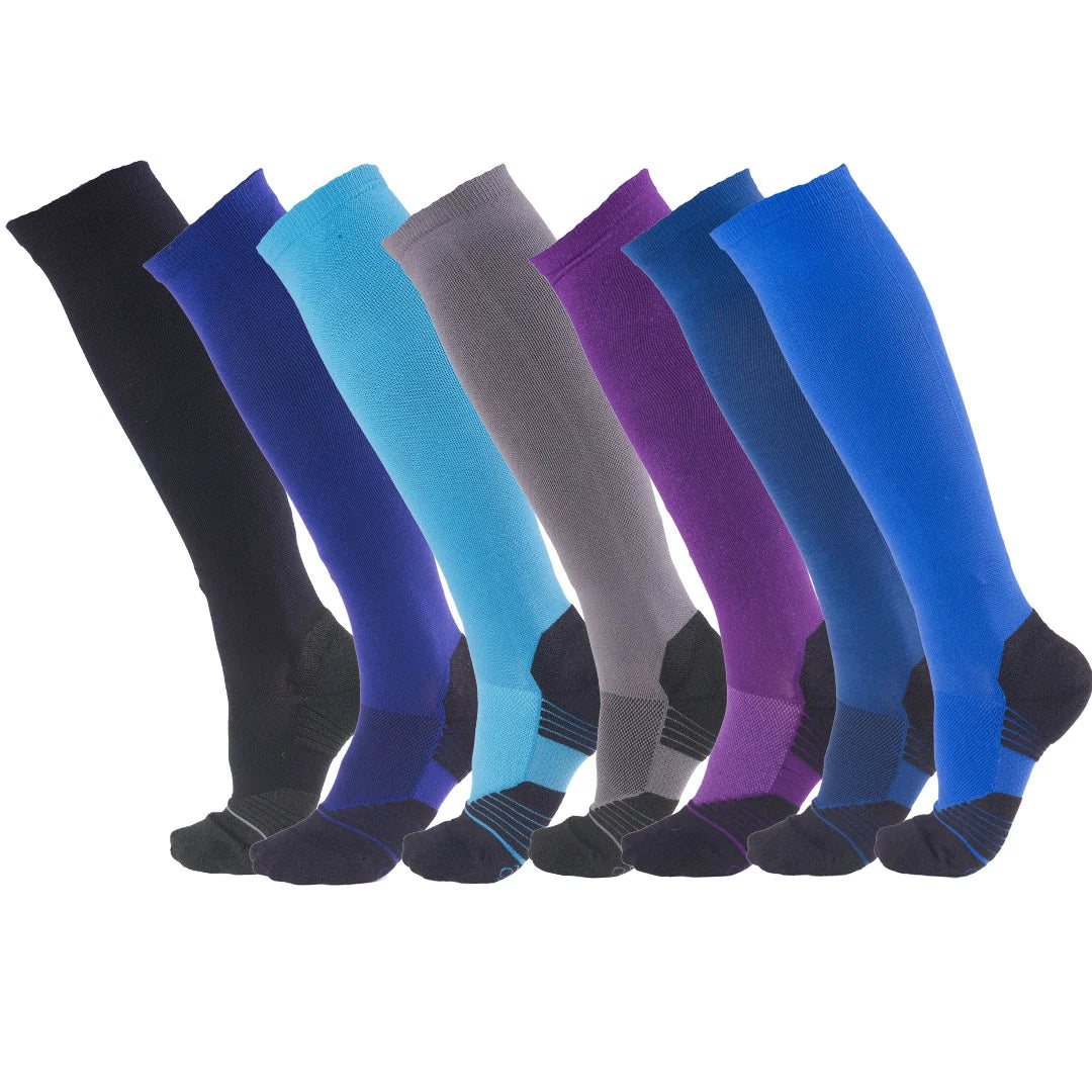 View of an assortment of colors of the Ovation Aerowic Boot Socks on a plain background