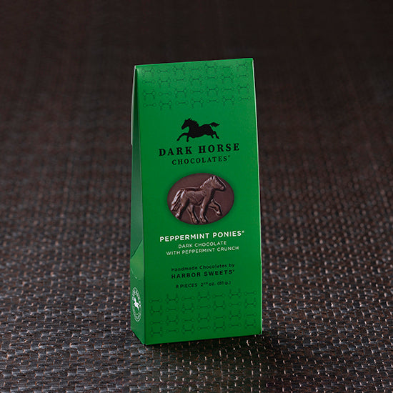 View of the Harbor Sweets Chocolate Peppermint Ponies Gable Box on a dark colored carpet background