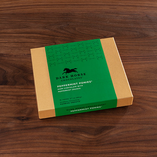 View of the Harbor Sweets Chocolate Peppermint Ponies Gift Box on a wood background