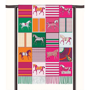 View of the Pink AWST Int'l Horses in Blankets Cashmere Scarf draped over a rod on a white background