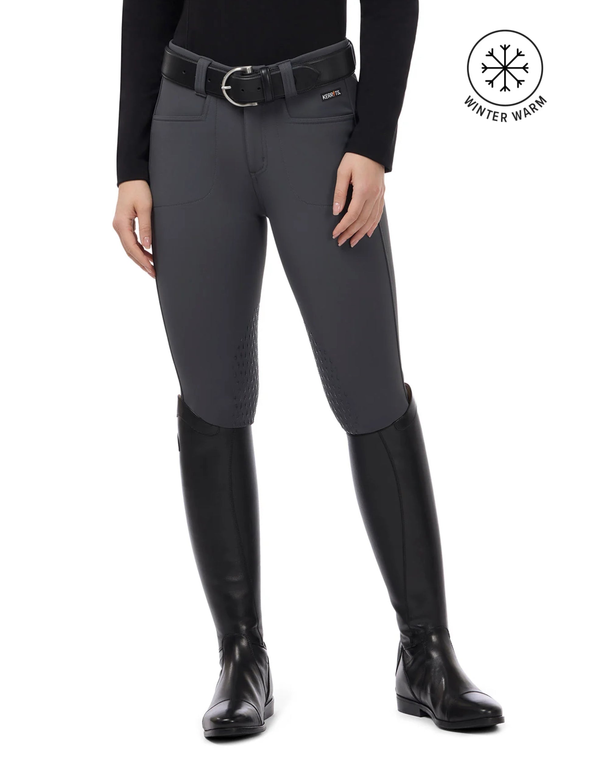 Front view of a female model wearing the Carbon Kerrits 3-Season Tailored Knee Patch Breech on a plain background