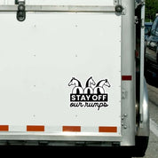 View of the Black Stay Off Our Rumps Dapplebay Vinyl Decal  on the back of a white horse trailer