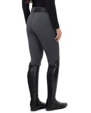 Angled back view of a female model wearing the Carbon Kerrits 3-Season Tailored Knee Patch Breech on a white background