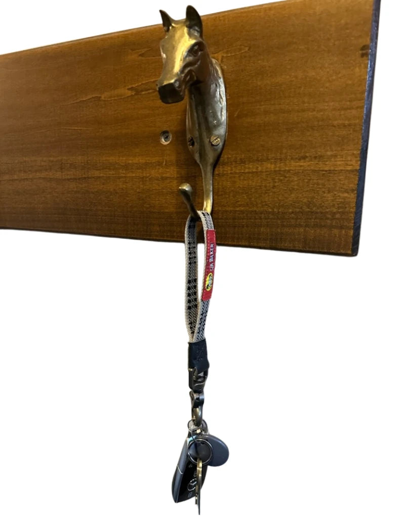 A Baker Keychain hanging on a horse hook
