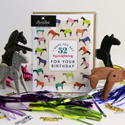 Front view of the I Hope You Get 52 Thoroughbreds For Your Birthday Hunt Seat Paper Co. Greeting Card in its packaging