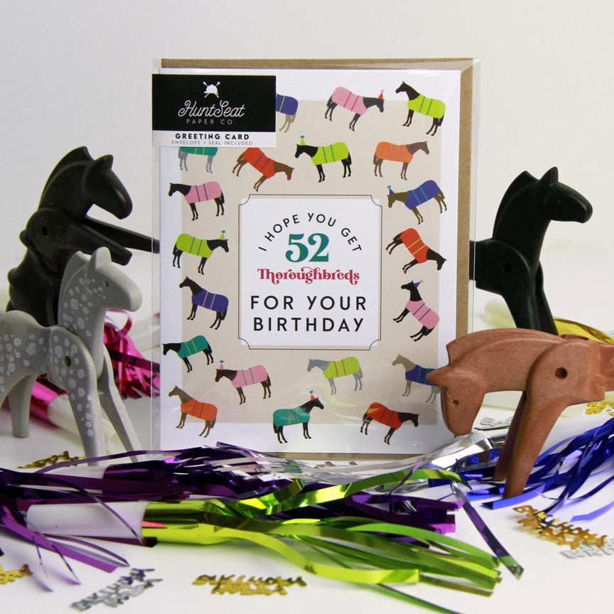 Front view of the I Hope You Get 52 Thoroughbreds For Your Birthday Hunt Seat Paper Co. Greeting Card in its packaging
