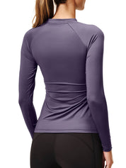 Back view of a female model wearing the Dark Violet Equestrian Stockholm Dynamic Long Sleeve Base Layer on a white background
