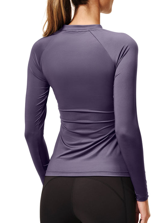 Back view of a female model wearing the Dark Violet Equestrian Stockholm Dynamic Long Sleeve Base Layer on a white background